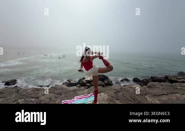 Yoga balance on foggy rocky shore influencer performing advanced ...
