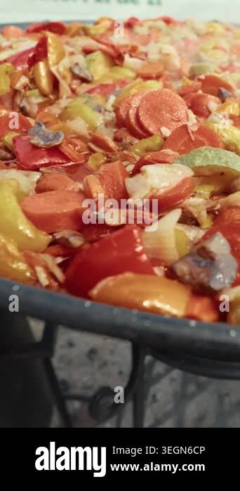Chopped vegetables including carrots, bell peppers, and onions are ...