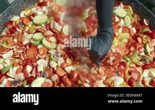 Chopped vegetables like carrots, bell peppers, and zucchini are ...