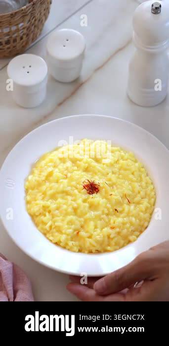 Close up vertical video of traditional risotto alla milanese with ...