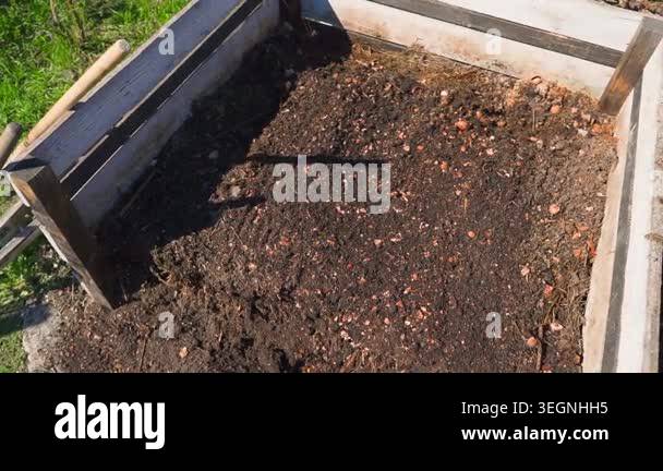 Top view of wooden compost bin filled with organic kitchen waste and ...