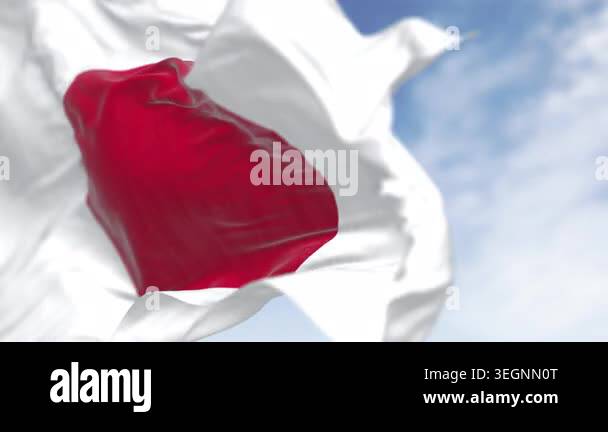 Japan national flag waving in the wind on a clear day. Red disc on a ...