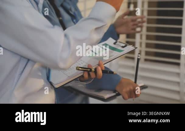 doctor writing on clipboard while standing in hospital Stock Video ...