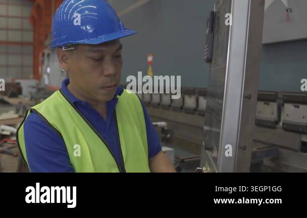 The workers, wearing safety helmets and protective gear, Factory worker ...