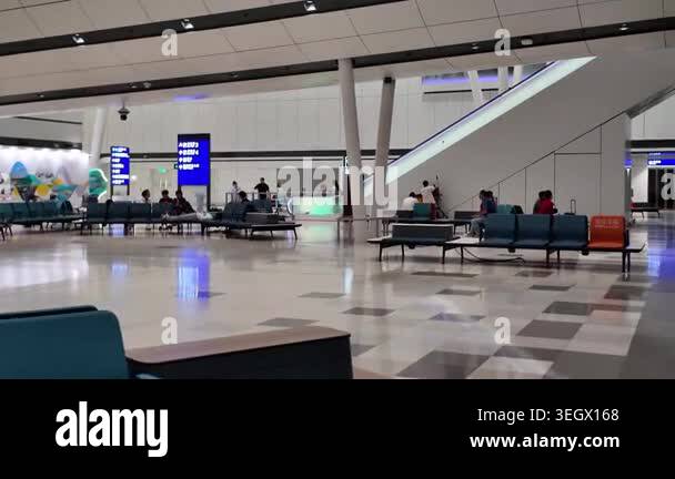 Hong Kong Airport arrivals hall with passengers and signage April 24 ...