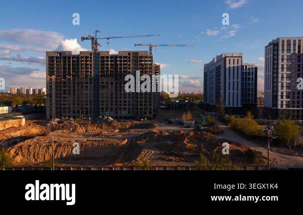 Image showcasing High-rise residential building construction site in Kyiv city at sunset ...