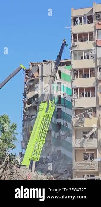 A building damaged by a Russian ballistic missile attack. Rescuers work ...