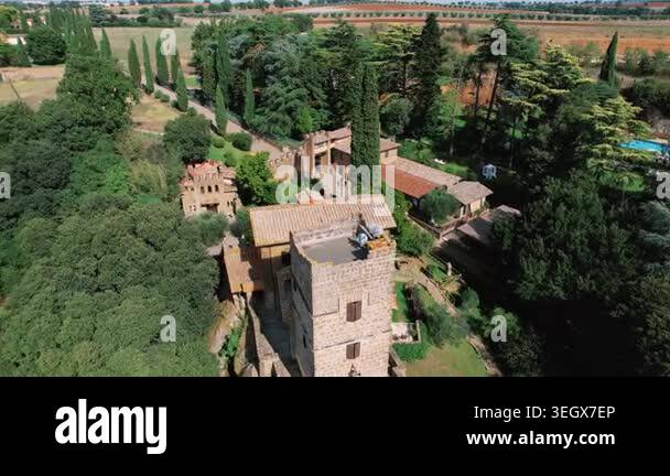 Aerial italian villa among cypress groves, stone tower, terracotta ...