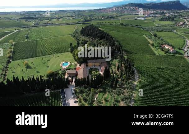 Aerial secluded villa in vineyard patchwork, circular pool and ...