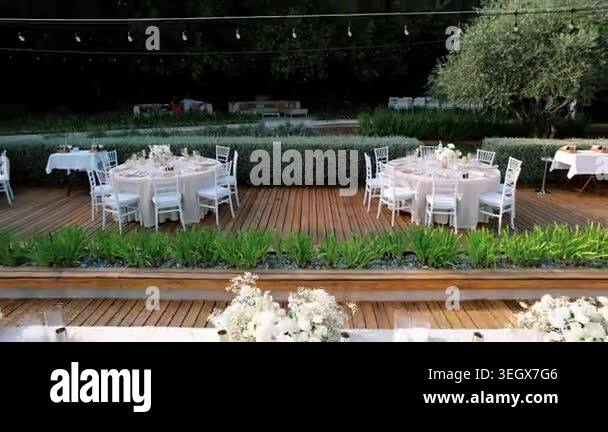 Intimate outdoor wedding reception wooden deck soft string lights hover ...