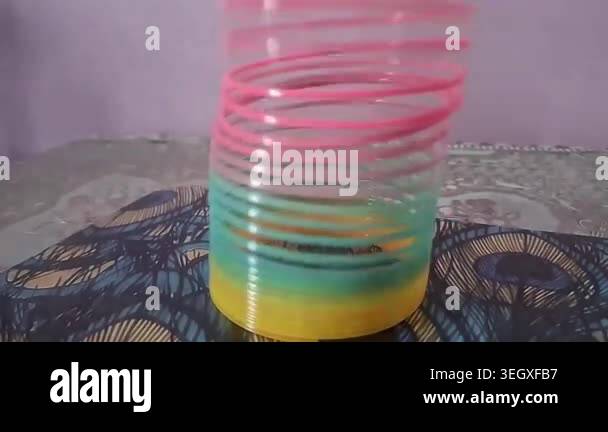 Colorful magic rainbow spring toy stretching dynamically with vibrant ...