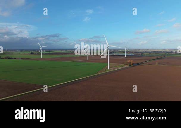 High angle aerial drone view showcasing green energy wind turbines and ...