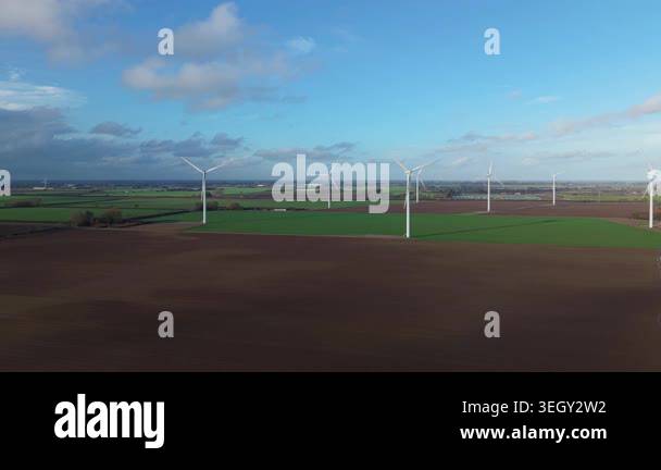 High angle aerial drone view showcasing green energy wind turbines and ...