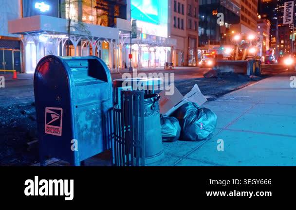 New York, USA, 15 April 2026: USPS mailbox beside nighttime street ...