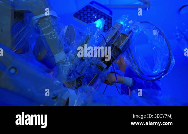 Unrecognized medic using surgical device stands behind the equipment ...