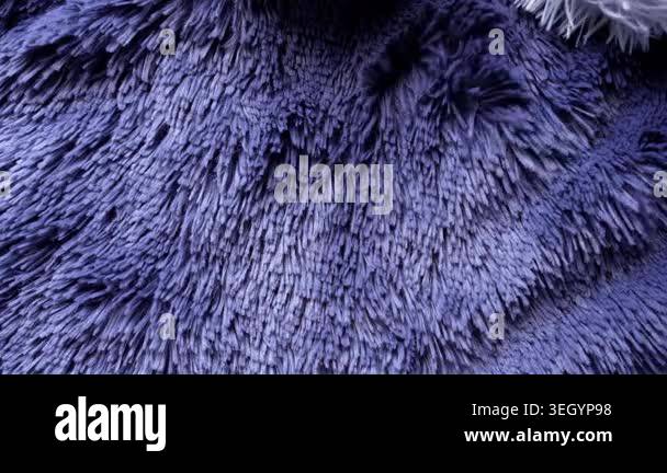 Fluffy blue faux fur texture blowing in the wind. Abstract background ...