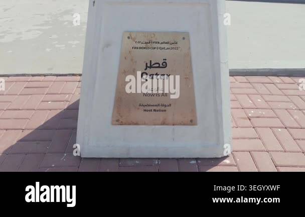 Informational sign displaying the name Qatar in Arabic and English on a ...