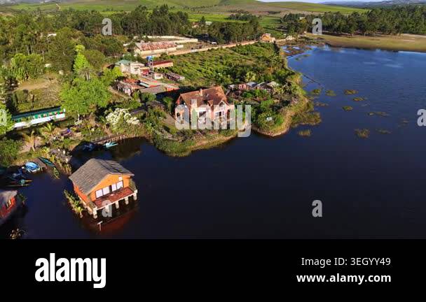 Aerial view of lush landscape featuring a river, residential buildings ...