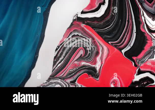 Aerial macro shot of red and white alcohol ink forming a spiral pattern ...