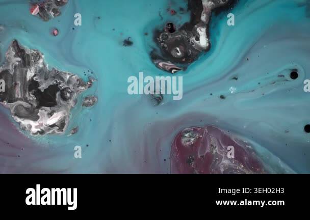 Wide angle macro shot of muted teal and mauve alcohol ink gently ...