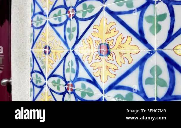 A smooth camera pan across a wall of traditional ceramic tiles ...
