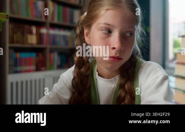 Sad Caucasian little child girl school kid looking at two big stacks of ...