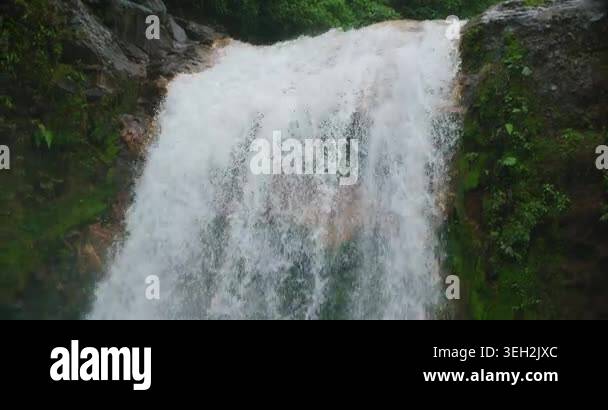 Close up of powerful white water cascading down waterfall rock face in ...