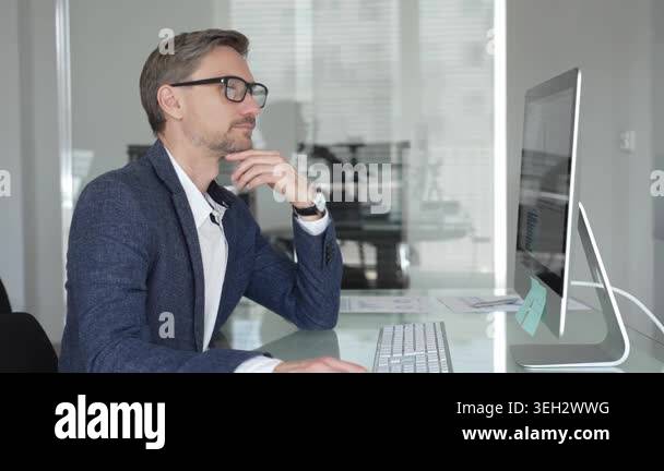Professional businessman wearing glasses and a blazer, working in a ...