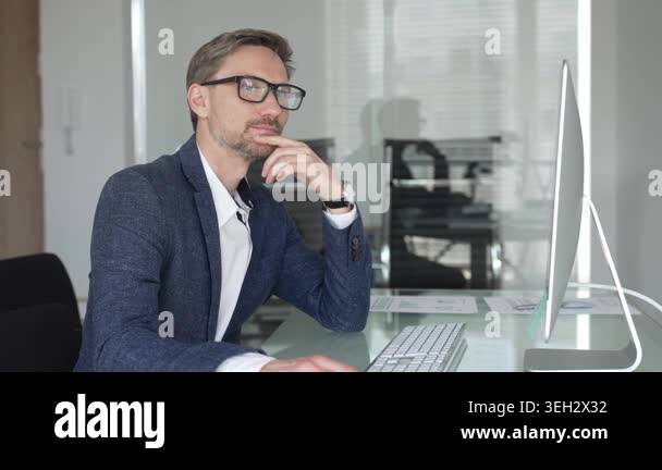Professional businessman wearing glasses and a blazer, working in a ...
