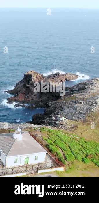 Aerial Lighthouse Standing Beside Rocky Shore, White Tower, Keeper ...
