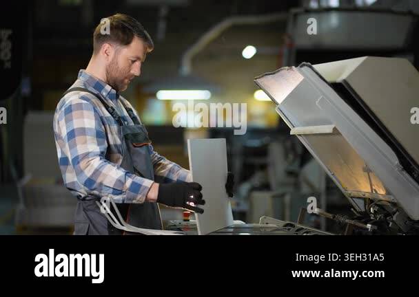 Professional printing house operator working with an industrial ...