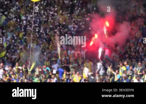 Football fans dance celebrate in smoky stadium with crowd joy, singing ...