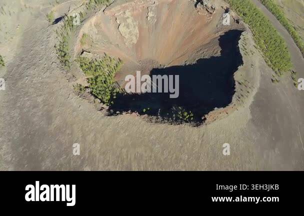 Aerial view shows volcanic crater mountain with eroded caldera slopes ...