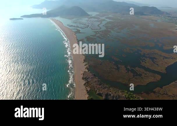Aerial view of reeds river channels in a coastal delta beside a long ...