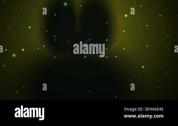 Glowing green particles float in dark space Stock Video Footage - Alamy