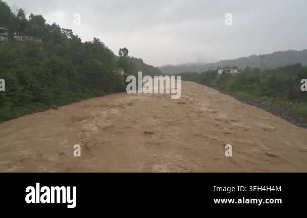 Muddy river in Bangladesh flows fast after rain with brown water, foam ...