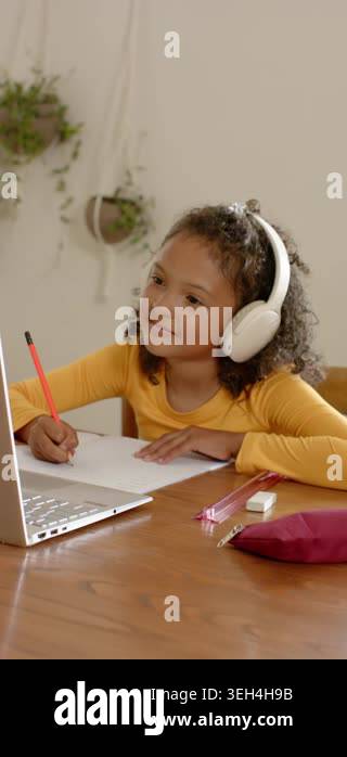 Vertical video: Opening page at home, girl in headphones glancing at ...