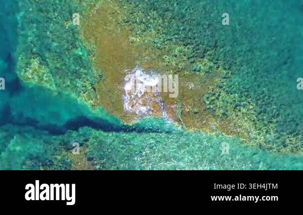 Aerial drone overhead of submerged rock and seamount in Chile with ...
