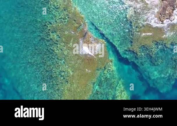 Aerial drone overhead of submerged rock and seamount in Chile with ...