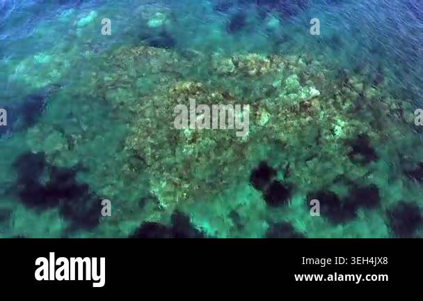 Aerial drone overhead of submerged rock and seamount in Chile with ...