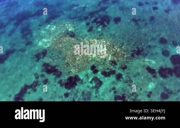 Aerial drone overhead of submerged rock and seamount in Chile with ...