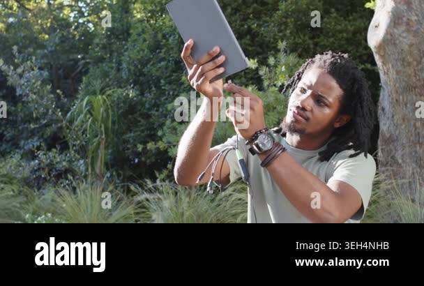 African American man inspecting tip, aligning green cable and inserting ...