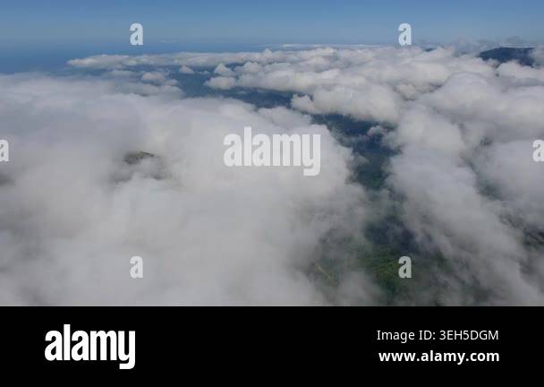Aerial forested mountains above clouds in the Bolivia Yungas, lush ...