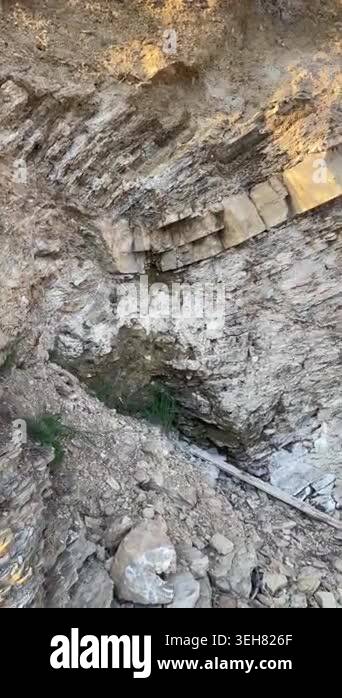 Vertical Pan Right of Sunlit Rock Formation, Rough Stone Texture, 4K ...