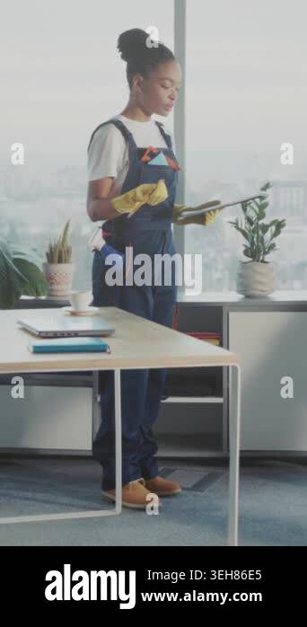 Black woman and white man collaborating over tablet and vacuum in ...
