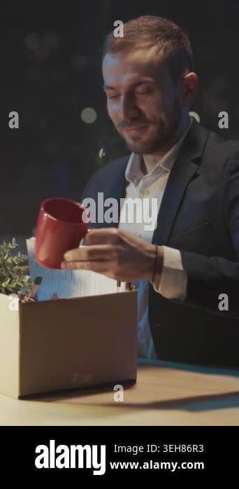 latenight office packing box white businessman holds plant and files ...