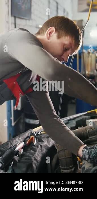 Car auto service - mechanic unscrews detail of car, close up Stock ...