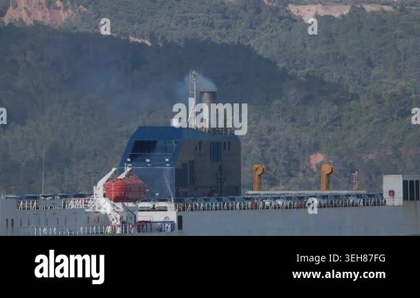 Large ship is docked at port with shipping containers stacked on deck ...
