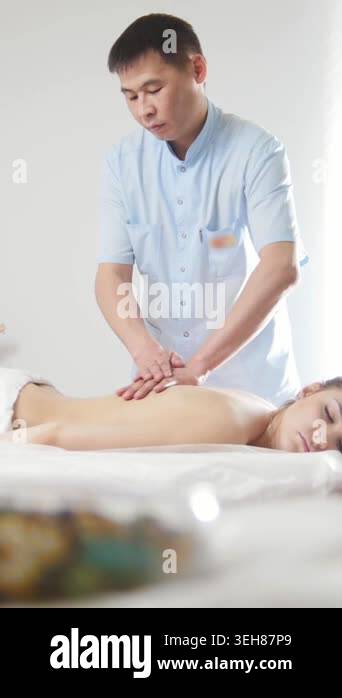 Doctor massagist and patient - young woman lying on massage table - spa ...