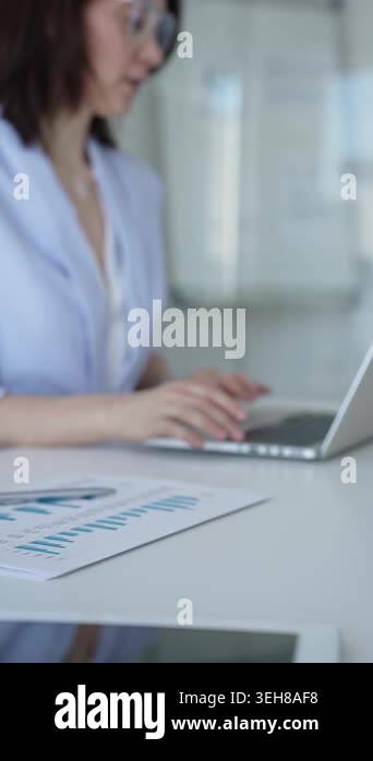 Businesswomans hands typing on a laptop keyboard, researching data ...